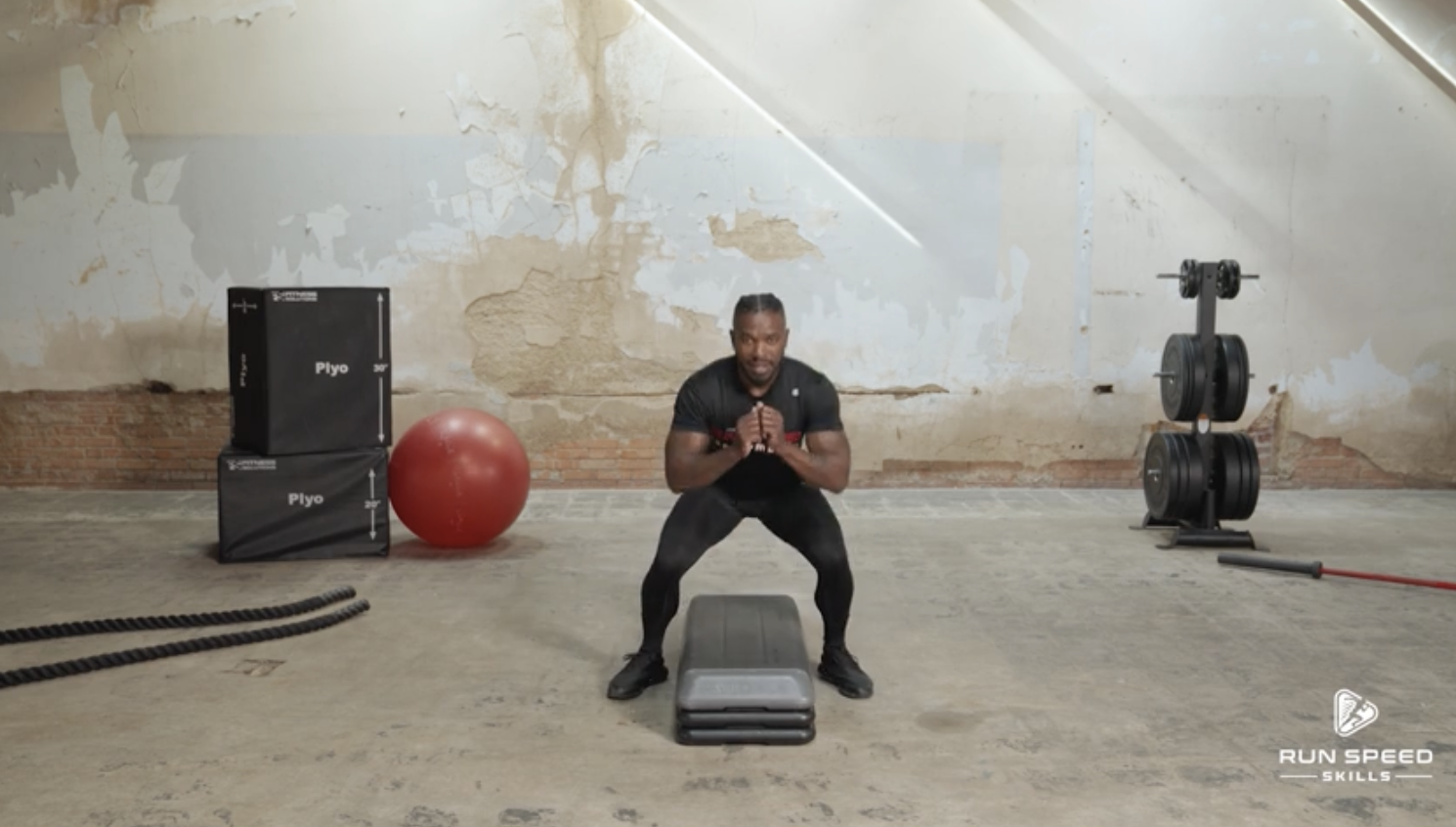 Man performing exercise with step platform indoors.